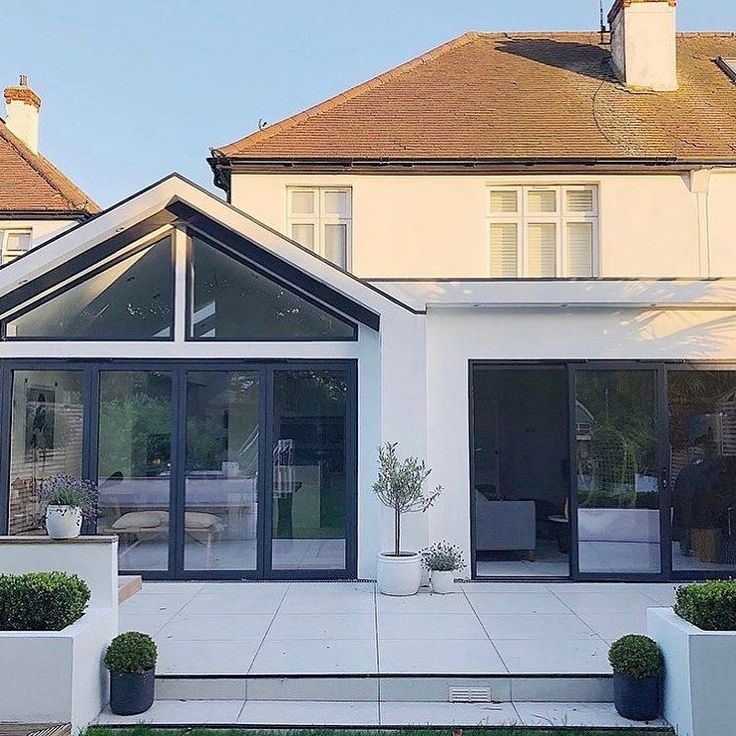 a large white house with glass doors and windows