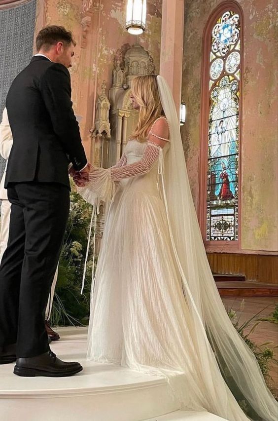 the bride and groom are getting ready to walk down the aisle at their wedding ceremony