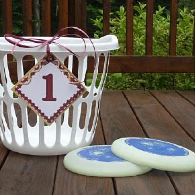 two cookies sitting on top of a wooden table next to a white basket with one