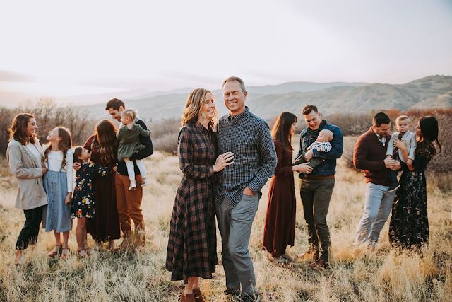 a group of people standing around each other in a field