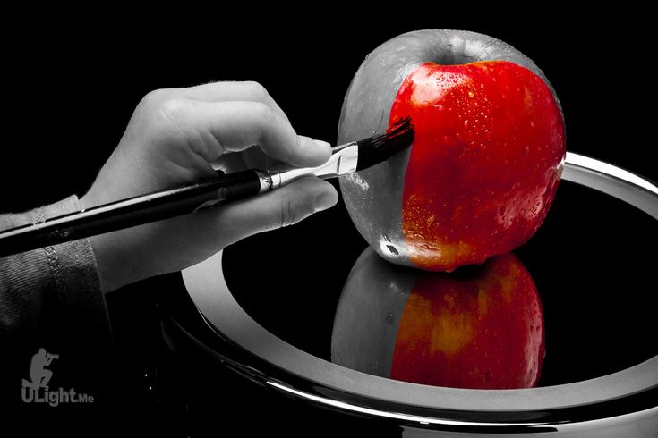 a person cutting an apple with a knife