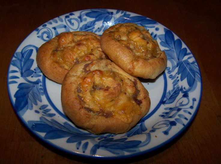 three small pastries on a blue and white plate