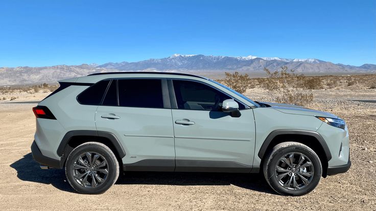 a light green toyota rav parked in the desert