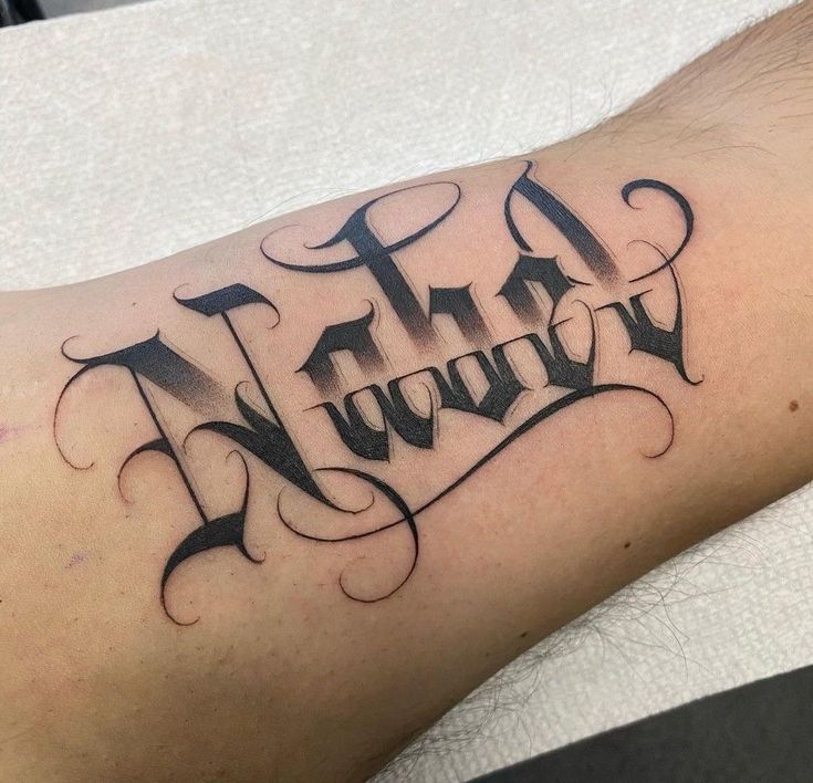 a man's arm with the word tattoo on it