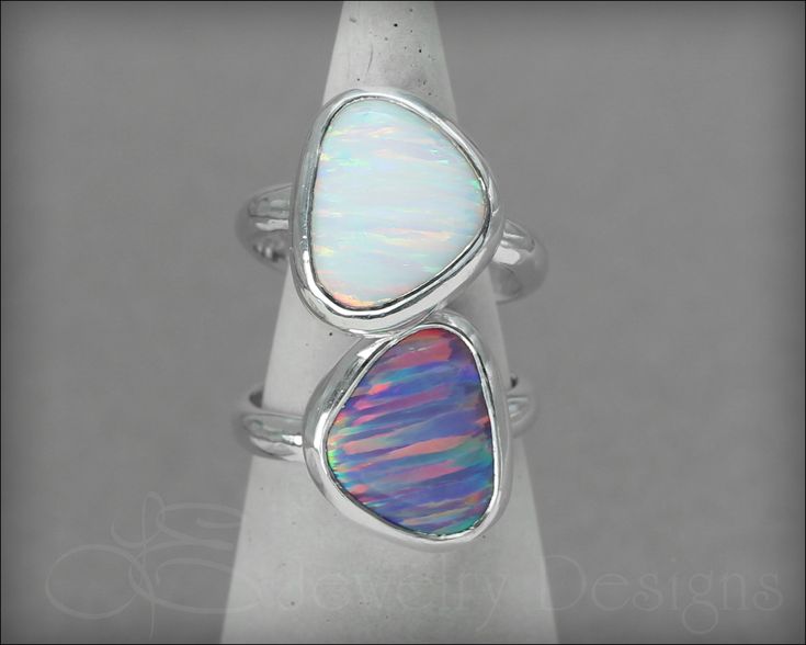 A beautiful and unique opal ring. The cut of the opal allows gorgeous, colorful stripes to sparkle in the light! The opal is set in a handcrafted, .999 fine silver bezel and sits on a half round sterling band. As seen at the GBK's Pre-Oscars Celebrity Gift Lounge and on celebrities Haley Orrantia and Leslie Zemekis. • sold individually• sterling silver, fine silver, synthetic opal• opal: ~ 15mm x 13mm• band width: 3.2mm Don't know your ring size? Purchase a Reusable Ring Sizer *This is a made to Iridescent Opal Jewelry For Anniversary, White Stackable Sterling Silver Opal Ring, White Cabochon Opal Ring In Sterling Silver, White Opal Cabochon Ring In Sterling Silver, Adjustable White Opal Ring In Sterling Silver, Adjustable Opal Ring, Sterling Silver Cabochon Opal Ring For Anniversary, Iridescent Opal Ring In Sterling Silver For Anniversary, Sterling Silver Opal Ring With Cabochon For Anniversary