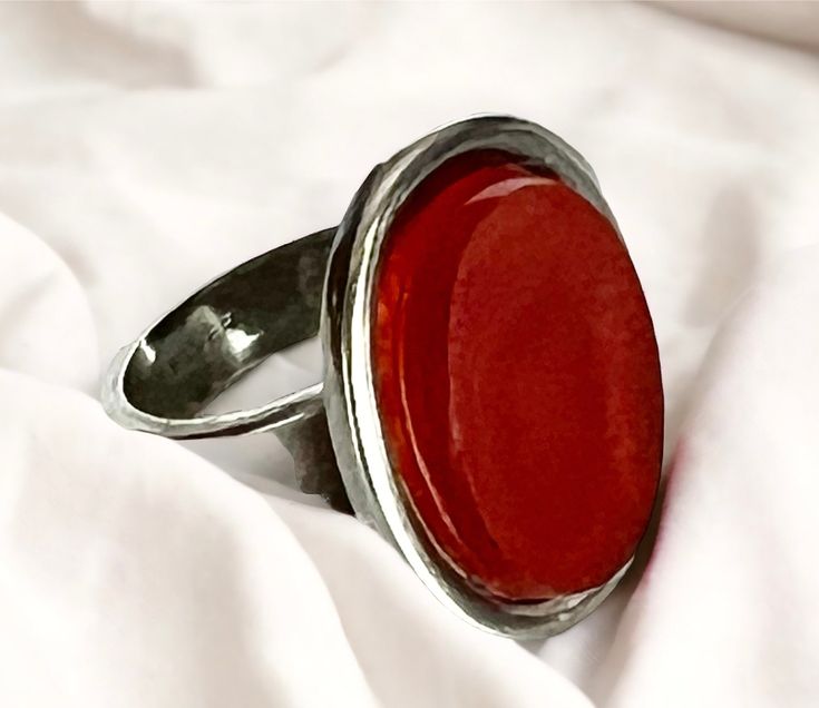 "Vintage ring made in Sterling silver featuring an orange stone (possibly carnelian) Dimensions: The top part of the ring measures approx. 1.8x2.2cm (0.71\"x0.87\"), the stone is 1.3x1.8cm (0.51\"x0.71\"). Size: 6 1/2 (US), 16.92mm Weight: 8.3 grams. In wonderful vintage conditions. ------------------------------------ * Thank you very much for visiting our Etsy store! All of our shipments are internationally tracked and require a signature upon receipt for your added security and peace of mind. We'll be delighted to combine or refund any excess postage for multiple items bought. If you have any questions, please do not hesitate to contact me." Orange Carnelian Ring Jewelry, Modern Carnelian Jewelry As Gift, Silver Carnelian Rings With Polished Finish, Silver Rings With Polished Carnelian, Silver Carnelian Ring Stamped 925, Silver Carnelian Ring Jewelry, Oval Carnelian Orange Ring, Sterling Silver Orange Ring With Polished Finish, Silver Carnelian Ring As A Gift