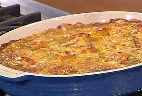 a blue casserole dish sitting on top of a stove next to an oven