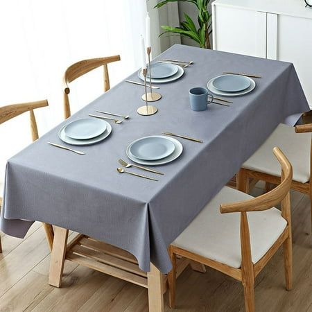 the table is set with plates and silverware on it, along with two wooden chairs