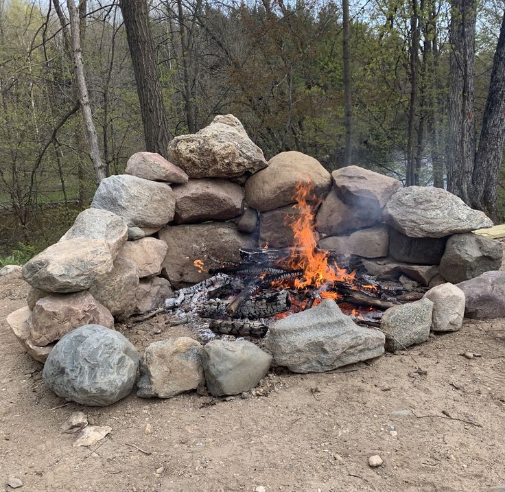 an outdoor fire pit with rocks around it