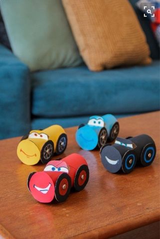 some cars are sitting on a table in front of a couch