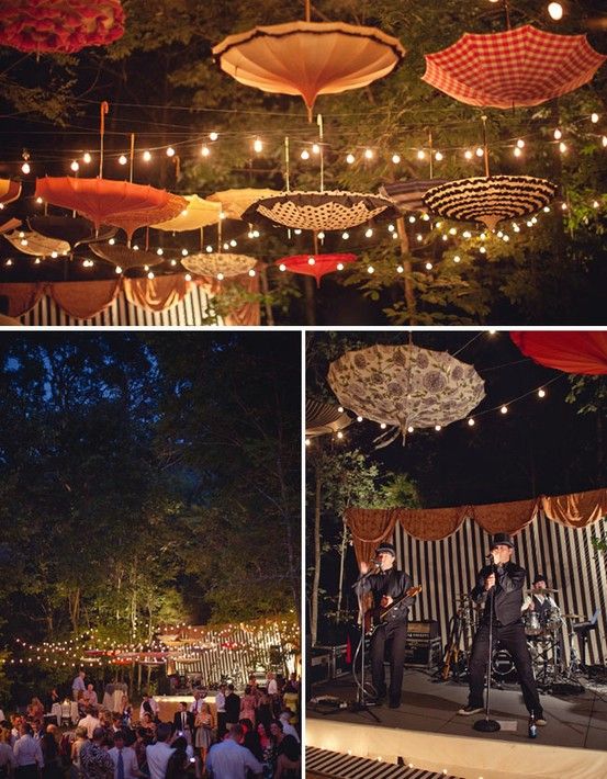 an outdoor concert with umbrellas hanging from the ceiling