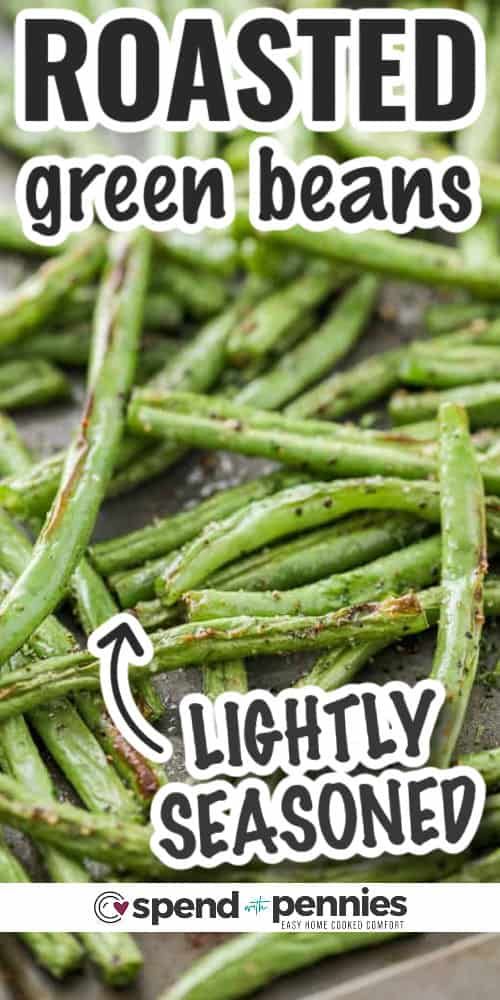 roasted green beans on a baking sheet with the words lightly seasoned in white lettering over it