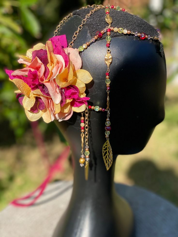 Gorgeous headpiece in warm pinks and golds. Delicate flowers, semiprecious beads and up-cycled jewelry. Perfect for festival, dance and fantasy costuming. Can be worn as a belt as well as a headdress or even a neck piece! Created with dancing in mind each piece comes with matching clips for securing in place. Summer Festival Bohemian Headband, Bohemian Summer Festival Headband, Multicolor Headpieces For Mardi Gras, Bohemian Adjustable Flower Hair Accessories, Bohemian Wedding Headband With Handmade Flowers, Adjustable Gold Hair Accessories For Festivals, Bohemian Festival Hair Accessories With Matching Headband, Bohemian Headband With Handmade Flowers, Summer Party Bohemian Headband