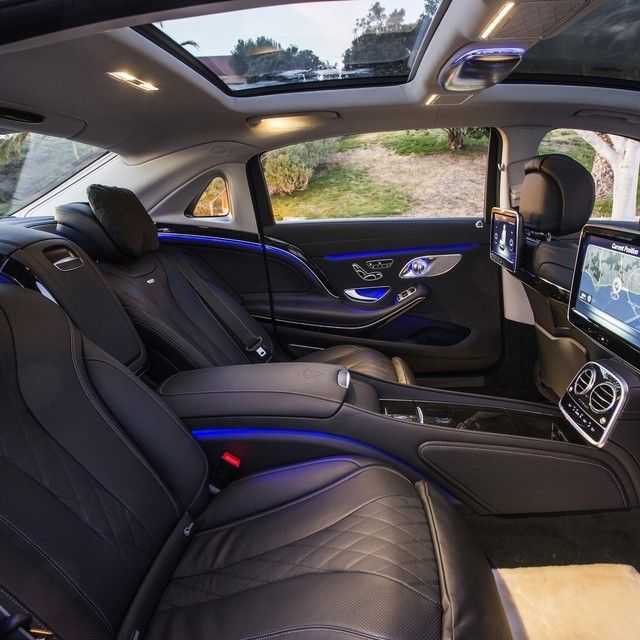 the interior of a car with black leather and blue stitching on the front seats