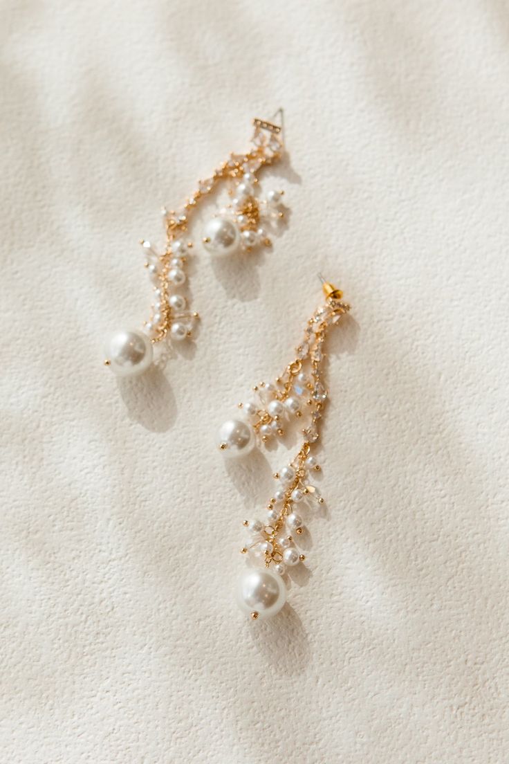 Introducing our Pearl Dangle Drop Earrings. These eye-catching earrings feature delicate pearl and crystal embellishments, perfect for any occasion. Their lightweight design ensures comfort and the post with bullet clutch back provides effortless wear. Elevate your style with these stunning earrings! Ivy City Co, Stunning Earrings, Crystal Embellishment, Elevate Your Style, Accessories Earrings, Your Style, Ivy, Embellishments, Dangle Drop Earrings