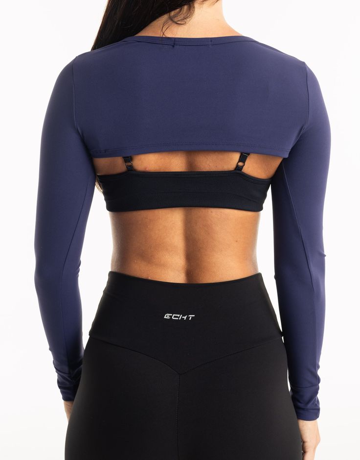 Functional athleisure at its finest. The Range Long Sleeve is the perfect garment to complete your workout look. Featuring a slim fit, super cropped length, the Range Long Sleeve is perfect to throw over your favorite ECHT sportsbra or with Range V3 Sportsbra as shown and matching Range Leggings! - Super Cropped Length - perfect with high-rise pants - Mix and match with your favourite ECHT sportsbra - Fabric: Super soft and breathable - Slim fit skims your body - Silver logo on sleeve - Breathability and ease of movement 81% Nylon, 19% Spandex Range V3 Sportsbra is sold separately. Stretch Crop Top With Built-in Bra For Training, Fitted Crop Top With Built-in Bra For Gym, Functional Cropped Top With Built-in Bra, Compressive Workout Crop Top With Built-in Bra, Fitted Crop Top With Built-in Bra For Pilates, Sports Crop Top With Built-in Bra And High Stretch, Fitted Activewear Crop Top With Built-in Bra, Fitted Crop Top Activewear With Built-in Bra, Fitted Crop Top With Light Support For Pilates