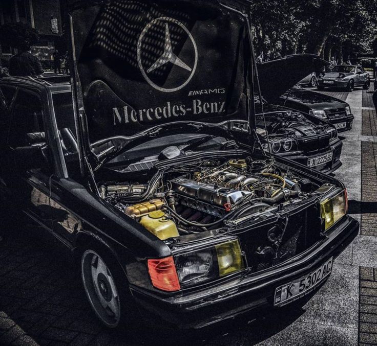 an old mercedes benz car with its hood open