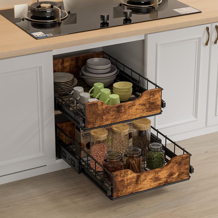 an open drawer in a kitchen filled with dishes