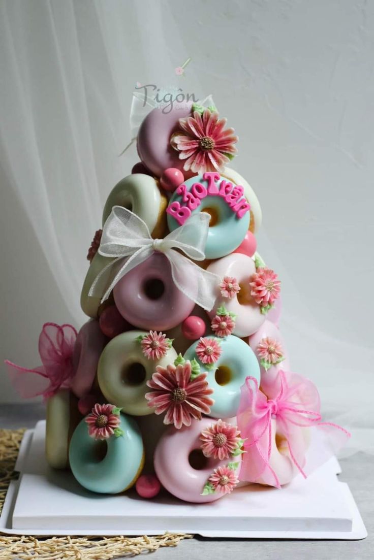 a decorated doughnut tree with pink and blue frosting