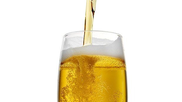 a glass filled with liquid and a straw sticking out of the top in front of a white background