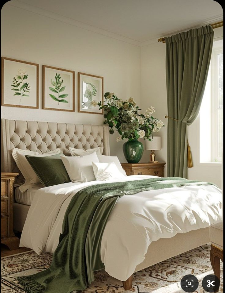 there is a bed with white sheets and green blankets on it, along with two vases filled with flowers