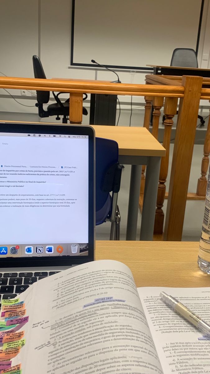 an open book sitting on top of a table next to a laptop computer