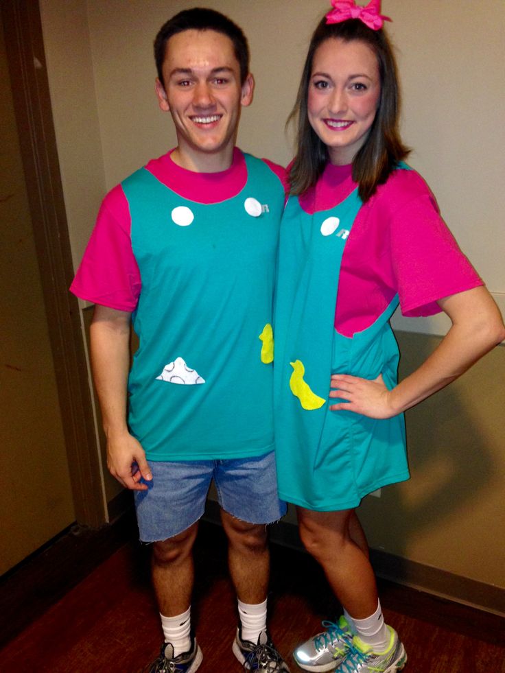 a man and woman in matching outfits standing next to each other