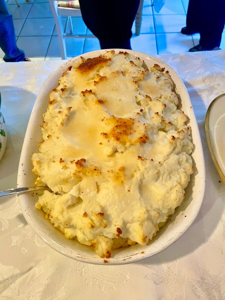 a dish of mashed potatoes on a table