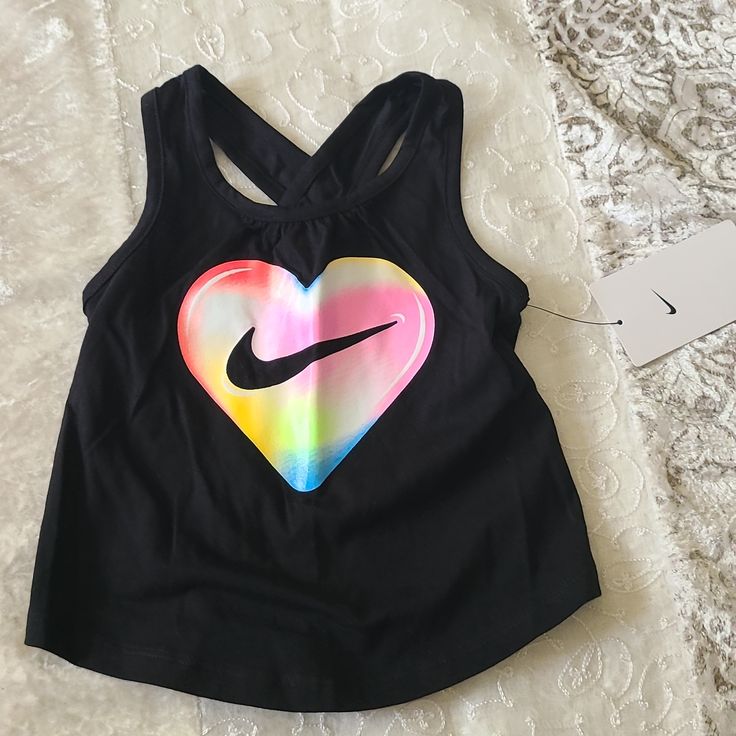 New The Nike Tank Is Sure To Be A Flowy Favorite. Featuring A Bright Graphic Print On Front And A Keyhole Detail On Back, This Tank Will Help Keep Kiddos Comfy At Play. Soft Cotton Fabric Feels Comfortable And Lightweight. Standard Fit For A Relaxed, Easy Feel. 100% Cotton Trendy Letter Print Tops For Playtime, Playful Black T-shirt For Spring, Cute Nike Tops For Summer, Cute Nike Summer Tops, Black Summer Playwear Tops, Nike Sporty Tops For Playwear, Sporty Nike Top For Playwear, Sporty Tops For Summer Playtime, Sporty Tops For Spring Playtime