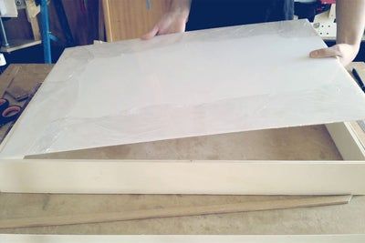 a person is making something out of white paper