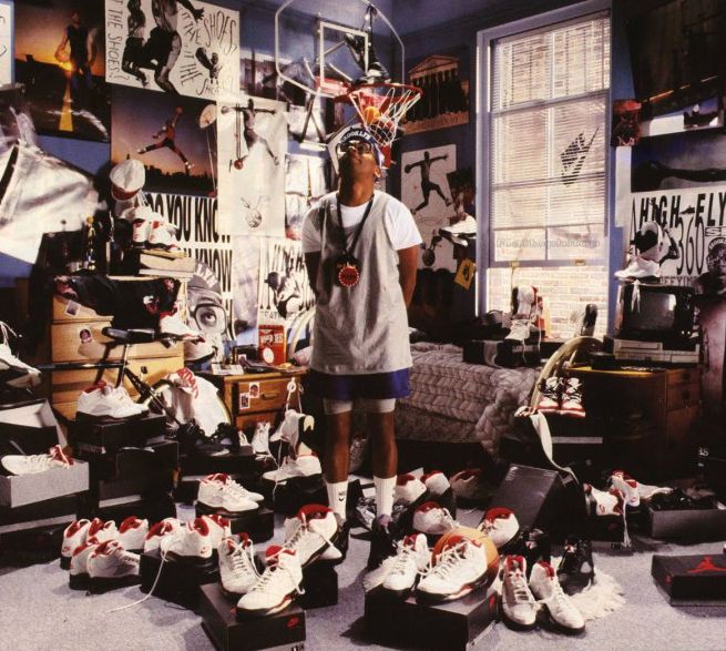 a man standing in front of a room filled with lots of shoes and basketball equipment