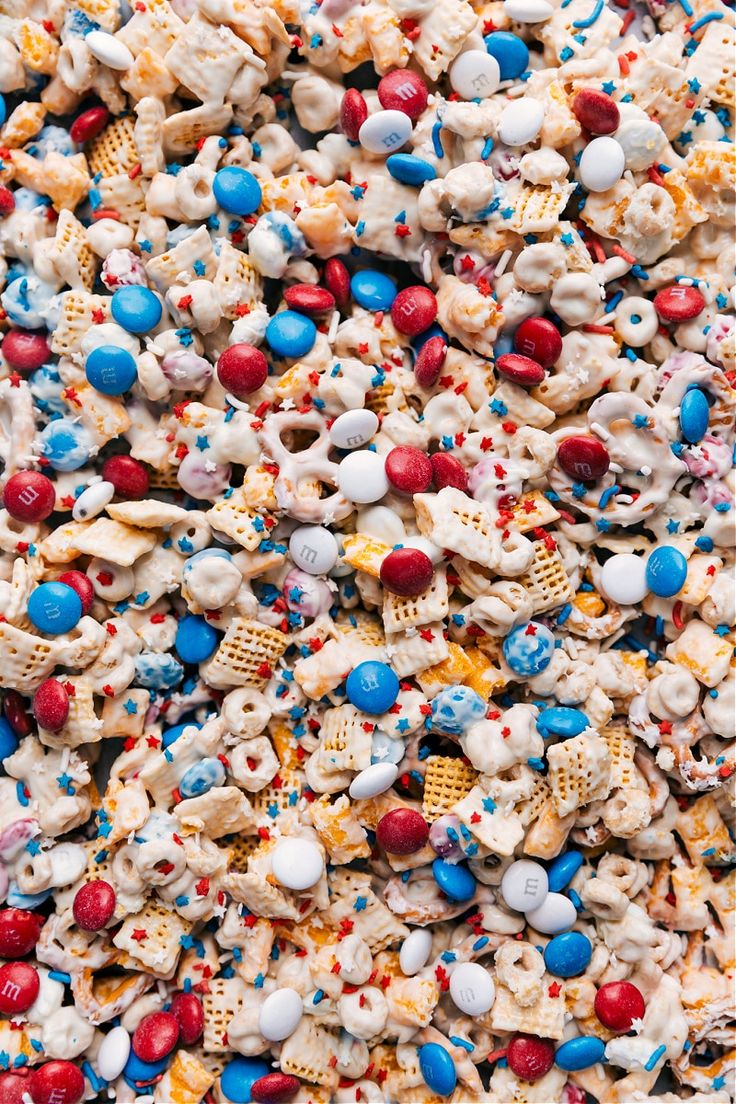 a pile of popcorn with red, white and blue sprinkles on it