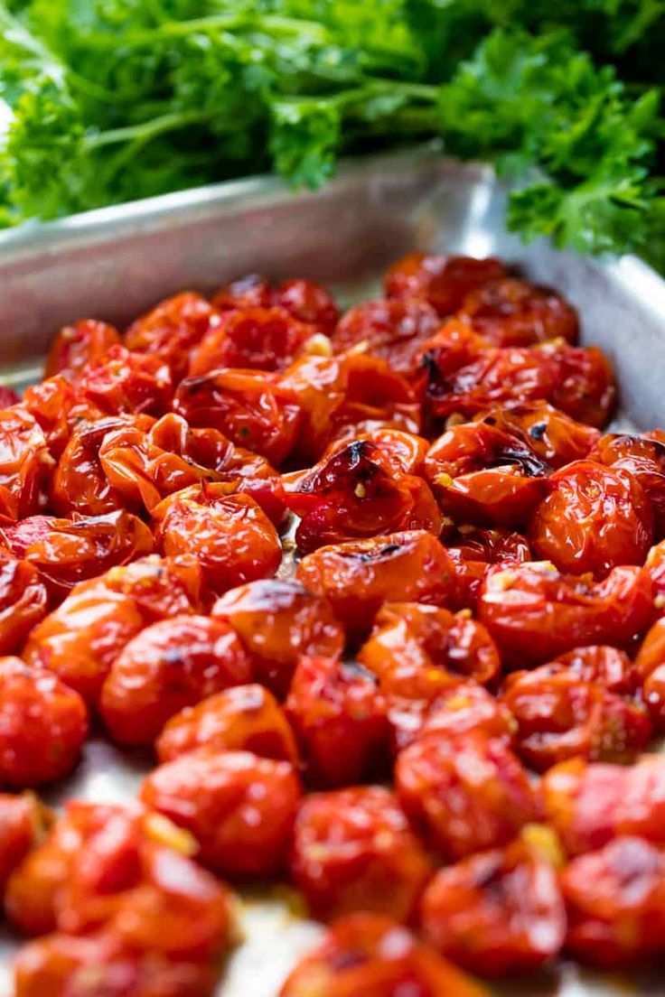 tomatoes and parsley in a metal pan ready to be cooked