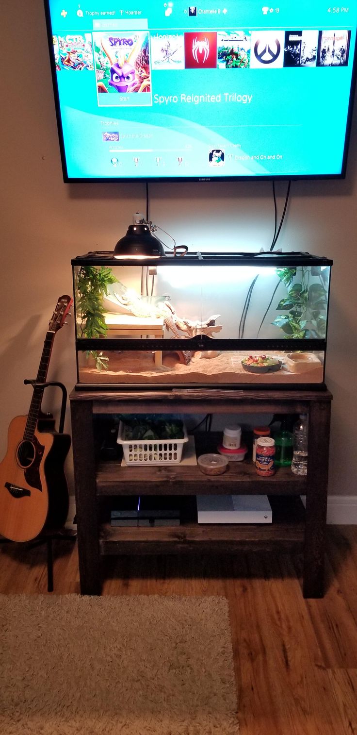 a flat screen tv mounted to the side of a wall next to a wooden floor