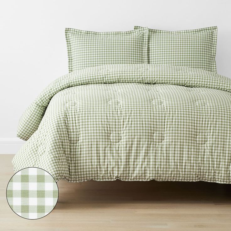 a green and white checkered comforter on a bed