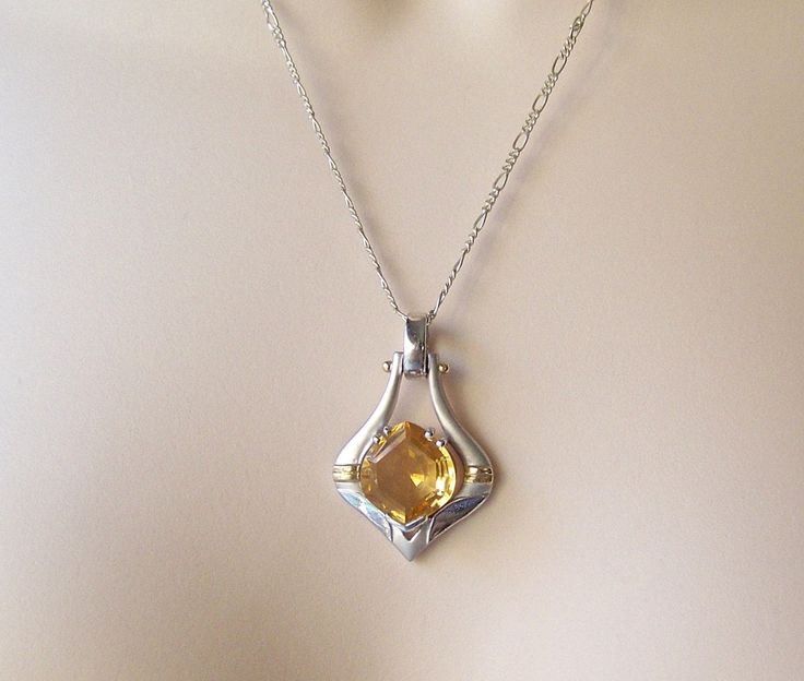 Vintage Sterling Necklace 14k Gold Accents Pendant 1990s. Featuring 15 ct Citrine Hexagon Gem Gift Idea for Mother Beautiful Sterling Silver Pendant Embellished with 14k Gold Accents sets off This Stunning 15 ct Hexagon Cut Citrine Gem. Very Large Citrine 15 ct Gem is in fine condition. No scratches or chips. Sterling silver chain necklace is 18 inches with a C clasp. Marked 925 Italy on chain clasp. Great Gift for Her, Mother's Day or Anniversary. Back of pendant is stamped 925 CS 14k The neckl Formal Yellow Necklaces With Polished Finish, Yellow Pendant Jewelry For Formal Occasions, Yellow Pendant Jewelry For Formal Events, Formal Yellow Necklace With Polished Finish, Art Deco Octagon Shaped Jewelry Gift, Formal Faceted Citrine Necklace, Formal Faceted Citrine Necklaces, Formal Octagon Birthstone Jewelry, Formal Octagon-shaped Birthstone Jewelry