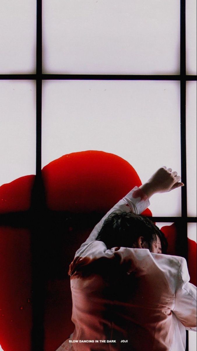 a man in white shirt and black pants doing a handstand on red chair