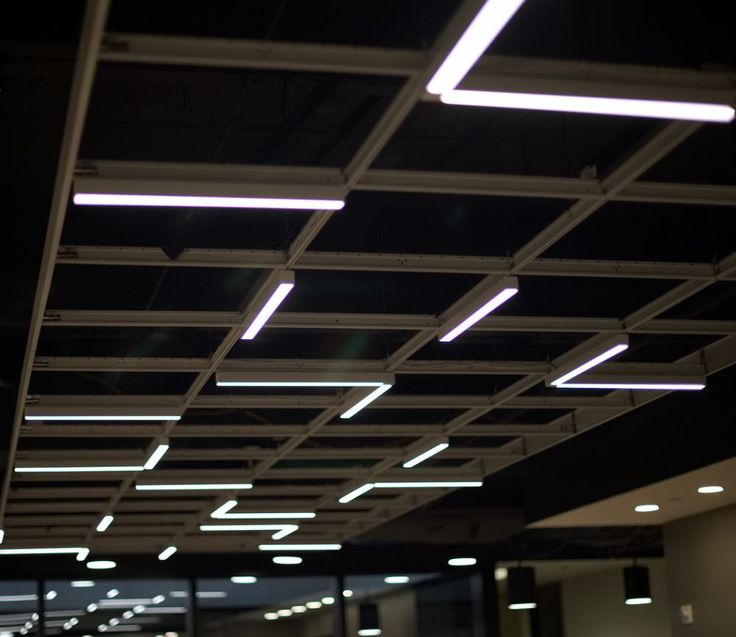 the ceiling in an office building is lit up with fluorescent lights