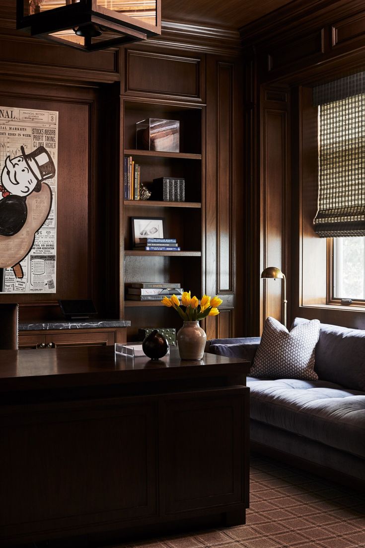 a living room filled with furniture and wooden walls