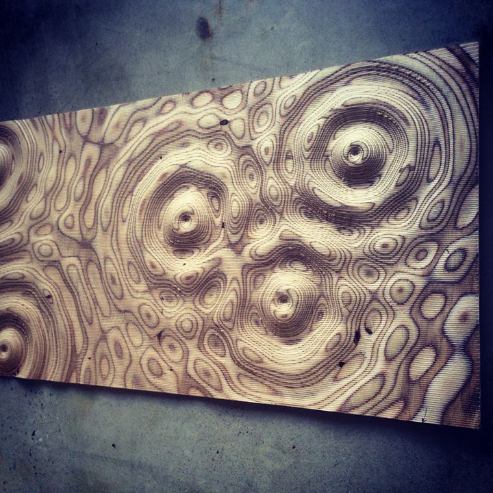 an abstract piece of wood with circles on it