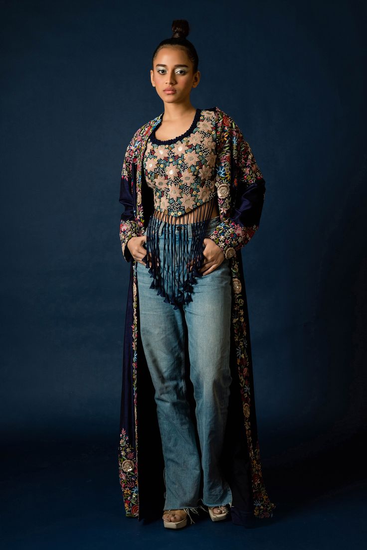 Blue silk long jacket, highlighted with floral and zardozi hand embroidery. Paired with an inner top with all over floral hand embroidery and fringed tassels.
Components: 2
Pattern: Hand Embroidery
Type Of Work: Floral, Zardozi
Neckline: Top: Round Neck
Sleeve Type: Jacket: Full Sleeves
Fabric: Silk
Color: Blue
Other Details: 
Note: Pant worn by the model is not for sale
Occasion: Sangeet,Party - Aza Fashions Festive Floral Print Long Sleeve Outerwear, Festive Long Sleeve Outerwear With Floral Print, Festive Long Sleeve Floral Print Outerwear, Fitted Floral Print Outerwear For Festive Season, Festive Fitted Outerwear With Floral Print, Round Neck Jacket, Floral Hand Embroidery, Embroidery Floral, Top Round