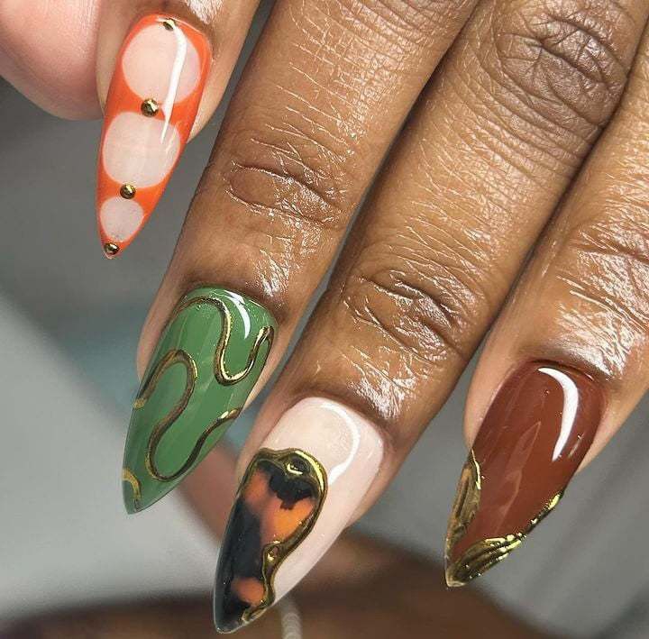 a woman's nails with different designs on them