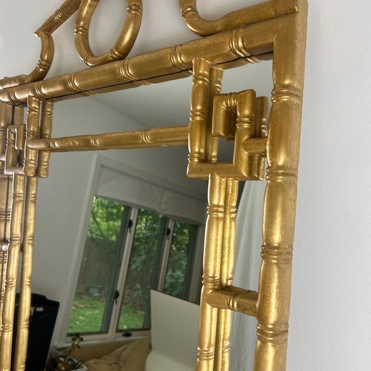 a large gold mirror hanging on the wall