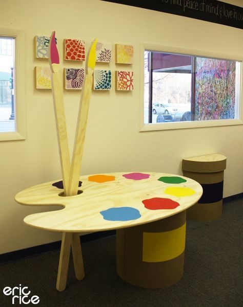 a table with paintbrushes on it in an office