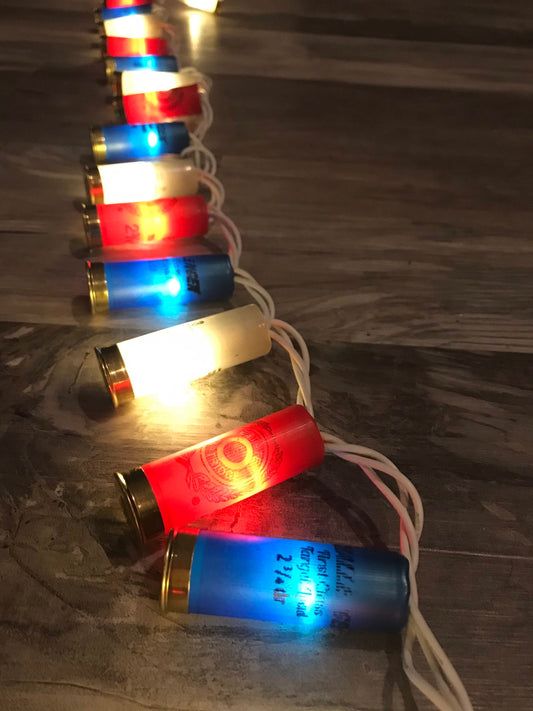 several batteries are lined up in the shape of a ladder with lights on them and some cords attached to it