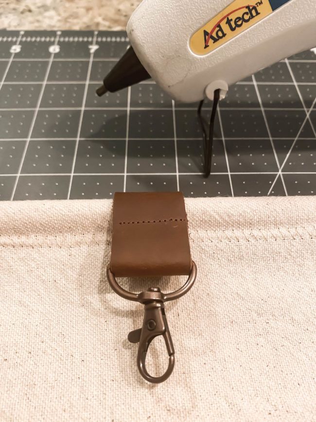 a pair of scissors sitting on top of a piece of fabric next to a stapler