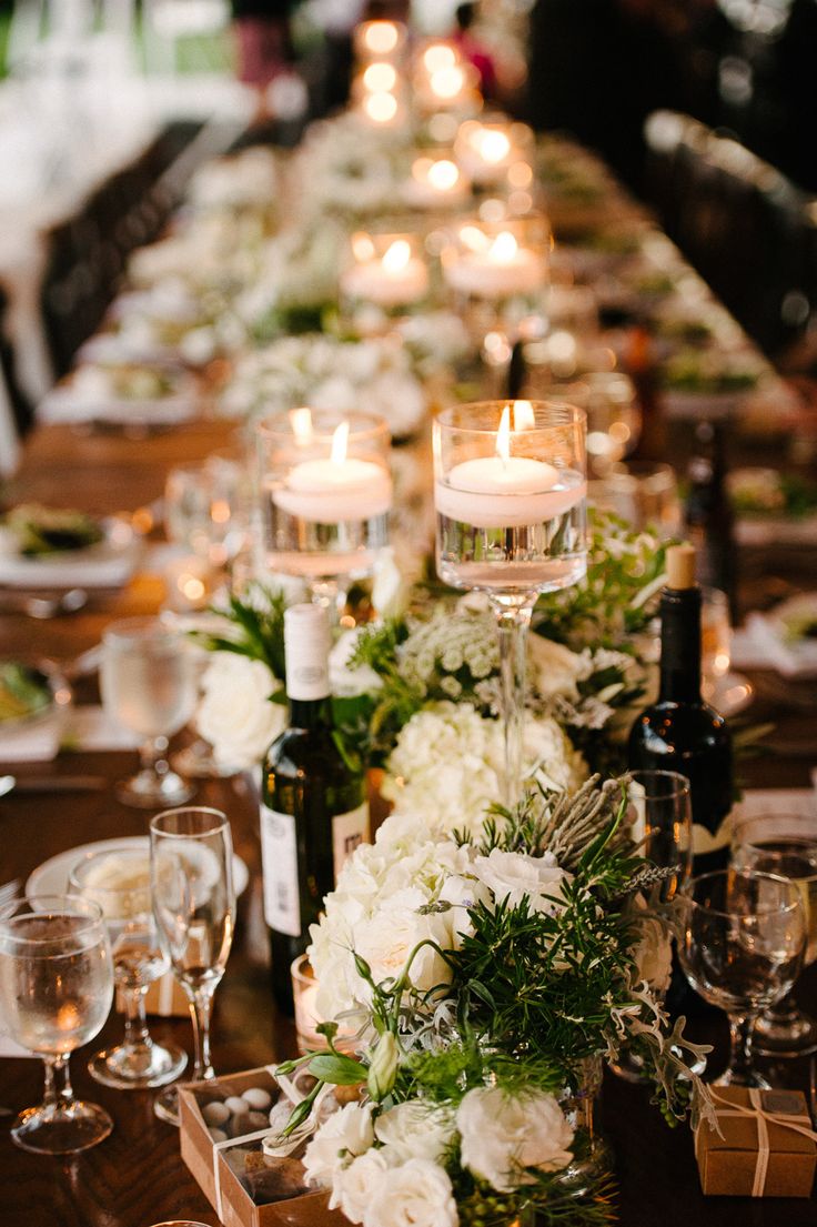 a long table with candles and flowers on it