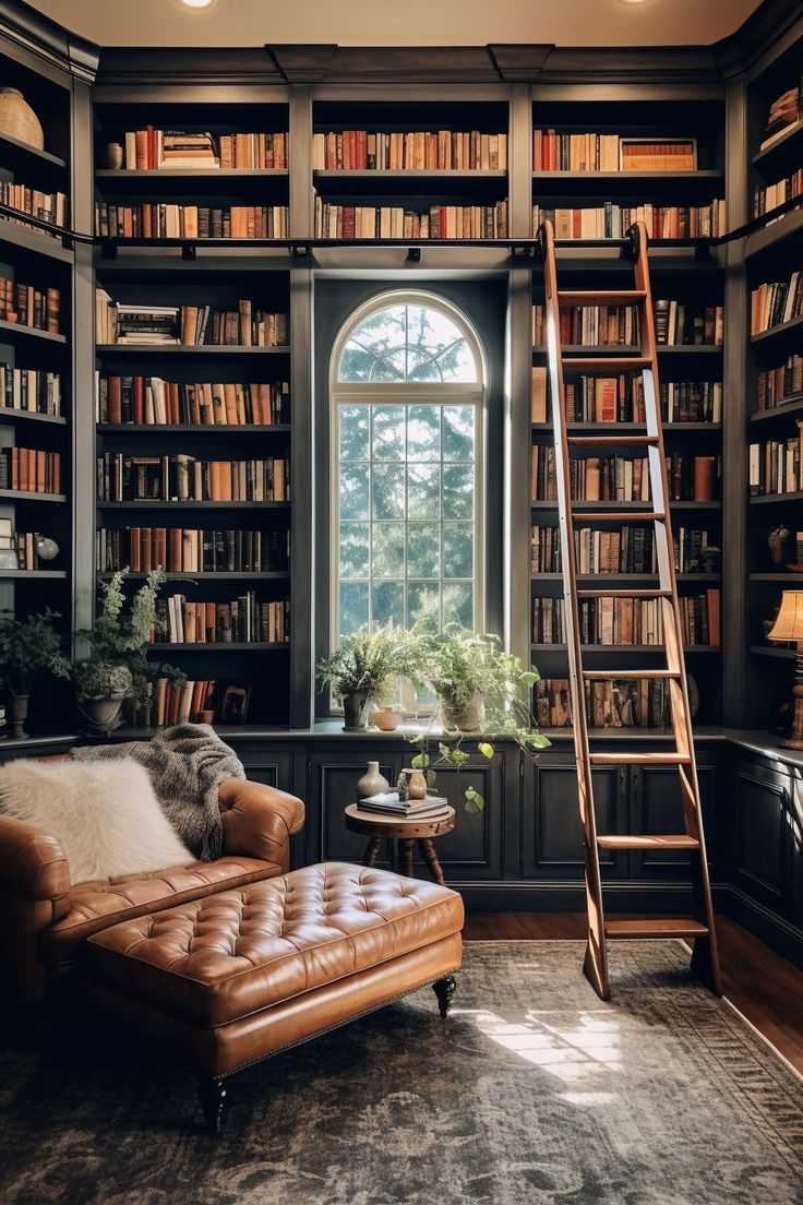 a living room filled with lots of book shelves and a leather chair in front of a window