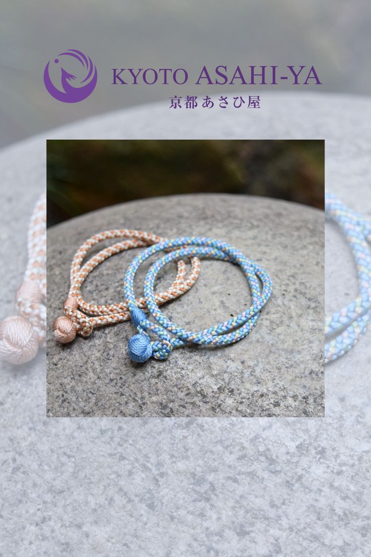 three bracelets are sitting on top of a rock, with the words kyto asahiya written in japanese