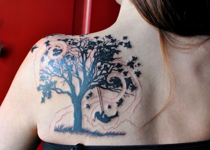 a woman with a tree tattoo on her shoulder